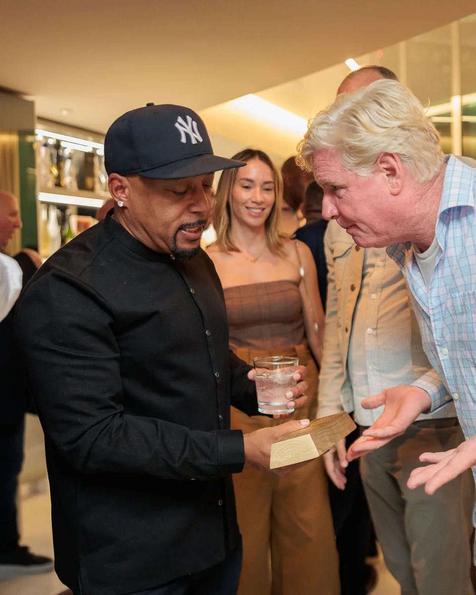 Daymond John in conversation with a guest at an art-focused private evening